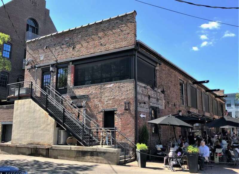 106 South Union Street in Old Town Alexandria, Virginia, has an eastern facade on Strand Street (left), and a northern facade on Wales Alley (right). This view is from Strand Street.