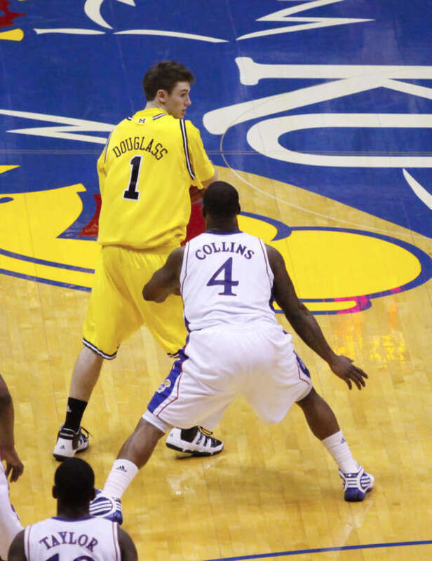 Stu Douglass of the 2009–10 Michigan Wolverines men's basketball team guarded by Sherron Collins