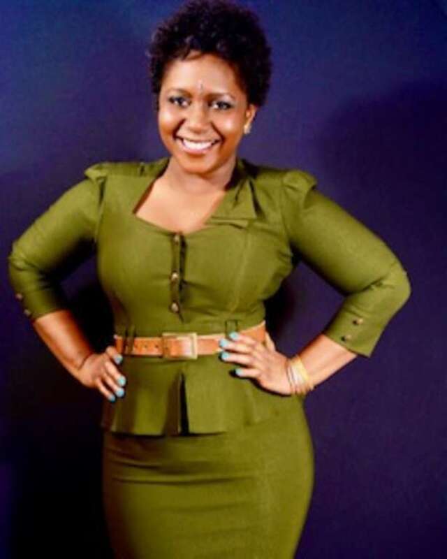 Aziza in a green suit