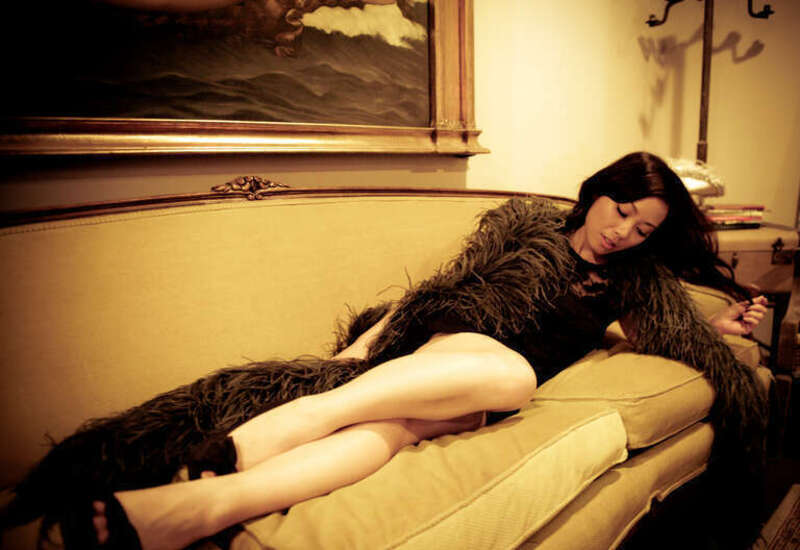 beautiful girl reclines on a couch