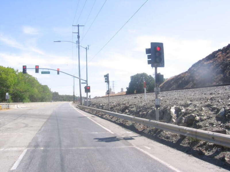 Looking southeast at the cut made by the old Southern Pacific line from what is now southern San José &quot;Coyote Valley&quot; neighborhood to Coyote, California.  The Metcalf Energy Center is partially visible in the distance to the right above the Caltrain