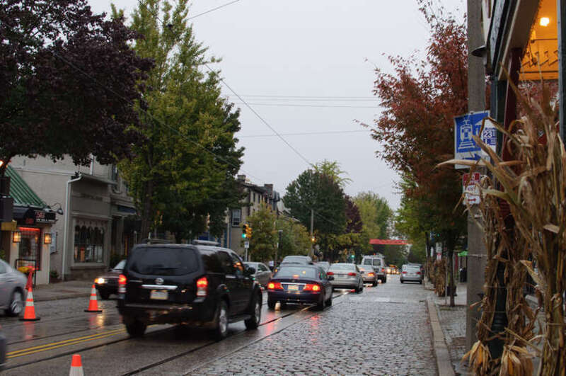I am on Germantown Avenue in Chestnut Hill, awaiting the No. 23 service to return to Center City.
The No. 23 used to be a streetcar service, whose tracks are still visible here, but the service has been run with buses since the early
