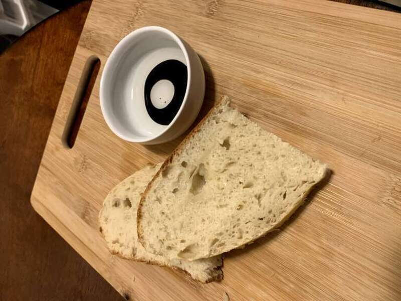 Two slices of homemade sourdough bread paired with oil for dipping