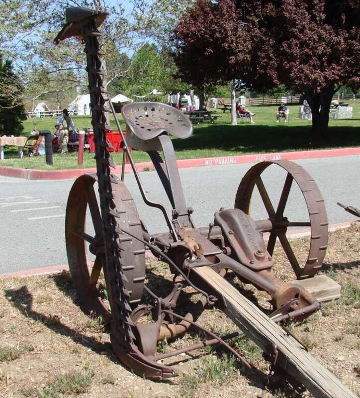 (1 in a multiple picture set)
This sickle, also called a hay mower, was one of the most labor saving inventions for farmers.  Now they could ride behind a team and cut a field of hay in less than a day.  The piece sticking up is the sickle bar and