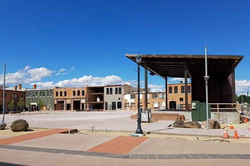 Construction progress at Indian Creek Plaza in Caldwell, Idaho, from the corner of Arthur Street and South Kimball Avenue, showing a rear view of seven buildings from the Caldwell Historic District, including from left to right on Main Street: