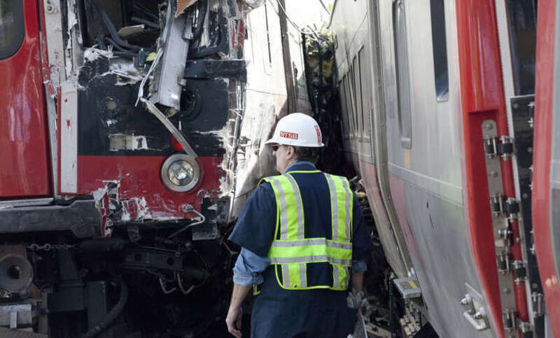 NTSB investigator Richard Downs documents the scene of the Metro North train derailment in Fairfield, CT.