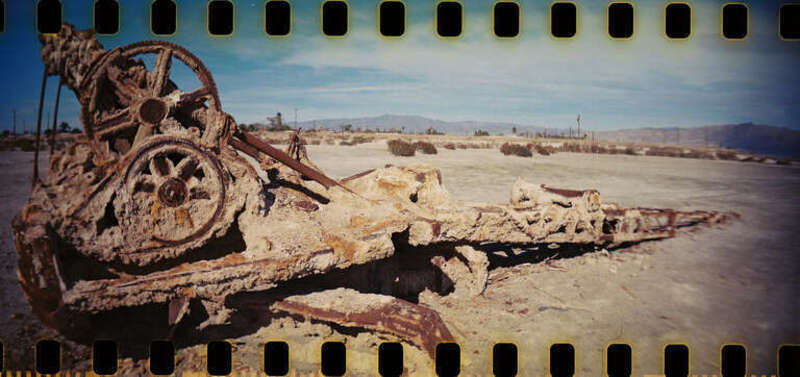 Nature conquers, as this dredger in Bombay Beach, CA is being eaten by salt. Lomography Sprocket Rocket.