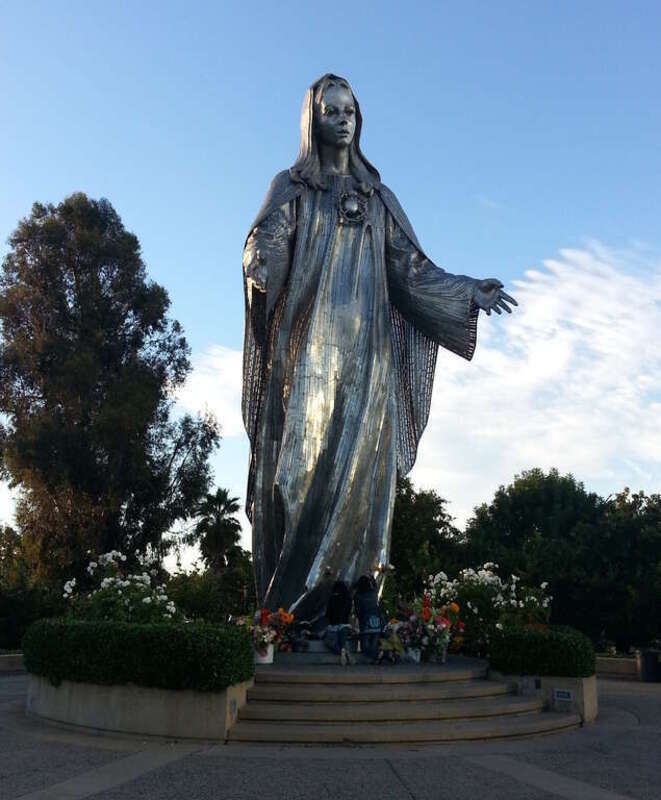 Statue of the Virgin Mary at Our Lady of Peace Shrine, Santa Clara. (Note for scale the venerators kneeling at her feet.)
