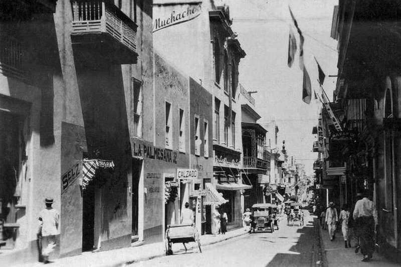1 photographic print&quot;Los Muchachos&quot; hardware store is visible on the left.