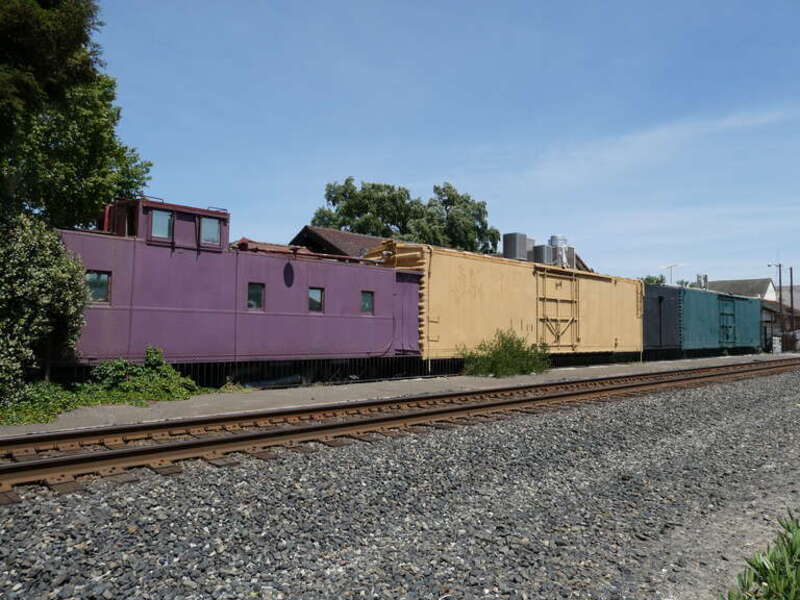 Old railroad cars behind the former Southern Pacific Railroad station in Turlock in May 2022