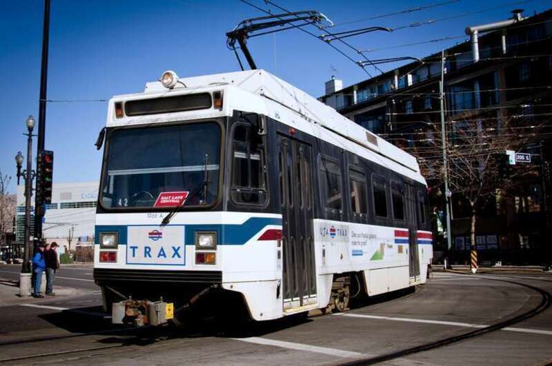 UTDC-built TRAX light rail car 1066, ex-San Jose and still painted in Santa Clara Valley Transportation Authority colors but with &quot;TRAX&quot; logos added, turning onto &quot;200 South&quot; from &quot;400 West&quot; (from southbound to westbound), in Salt Lake City. These