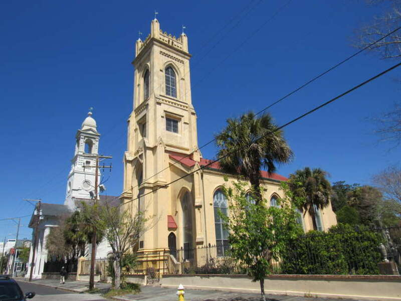 St. John's Lutheran Church (background) and the Unitarian Church of Charleston (foreground) along Archdale Street in Charleston, South Carolina.