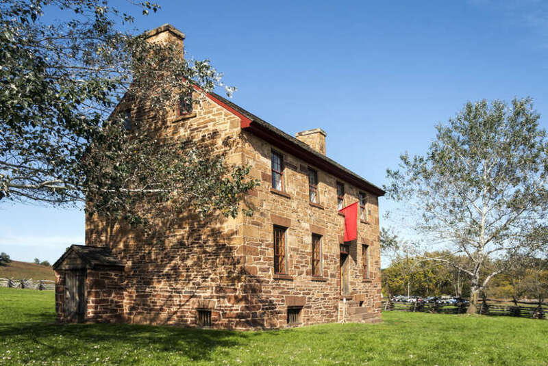 The Stone House at Manassas National Battlefield Park, Manassas, Virginia, USA, with the red Civil War-era hospital flag..