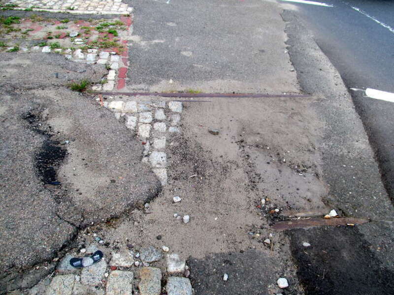 Remains of tram tracks at the site of the former Sullivan Square station, seen in July 2015. These tracks connected lines on Main Street (after 1940, numbered as route 92 and 93) and Cambridge Street (known as route 88 while a streetcar, then 91 as a