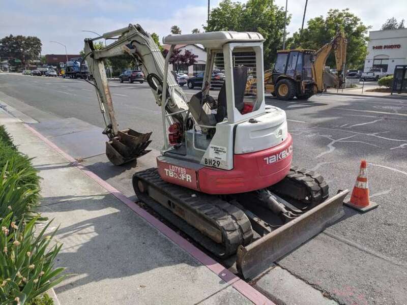 A Takeuchi TB53FR midi excavator parked on Winchester Ave in Campbell, California.