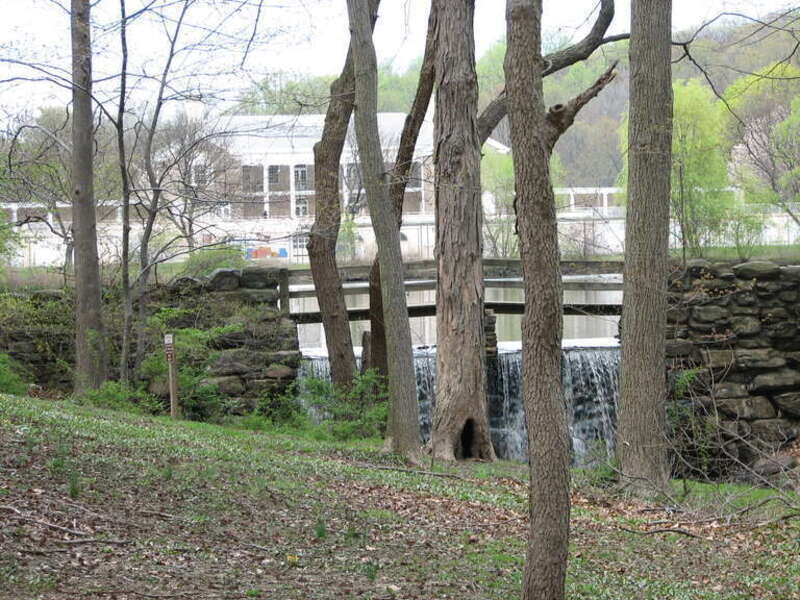 Photo of Tibbett's Creek and waterfall with park administration building in background.