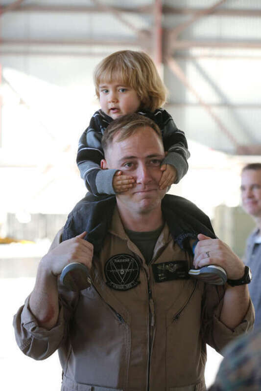 U.S. Marine Corps Capt. William R. Houck with Marine Aerial Refueler Transport Squadron (VMGR) 352, Marine Aircraft Group (MAG) 11, 3rd Marine Aircraft Wing (MAW), holds his son on his shoulders on Marine Corps Air Station Miramar, Calif., Jan. 15,