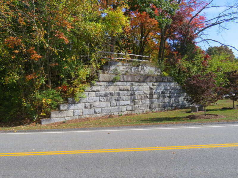 The remaining abutment of a bridge that formerly carried the West Medway Branch over Village Street in West Medway, seen in October 2020. The line was closed in 1966, and the bridge deck was removed within three years. Village Street was later