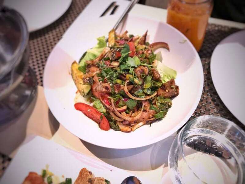 YUM NUAH (Thai Beef Salad) Red onions, green onions, tomato, cucumbers, cilantro, fresh chilies mixed with homemade sauce, served on bed of greens at Lotus of Siam in Las Vegas, Nevada