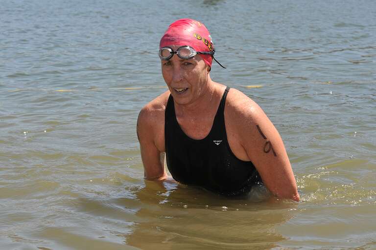 Cindy Cook, age 59, from North Hills, CA, participates in the 2016 SoCal Cup Open Water Festival. Cook, pictured exiting the finish area, competed in the women’s masters championship round, one mile distance. Cook finished 13th overall and 2nd within