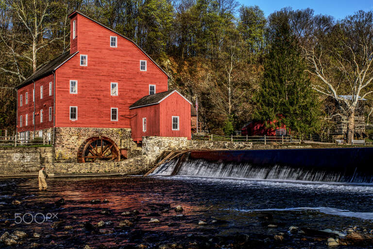 500px provided description: A couple more photos showing the Clinton, NJ landmark. [#sunrise ,#river ,#New Jersey ,#Clinton ,#Fisherman ,#Red barn]