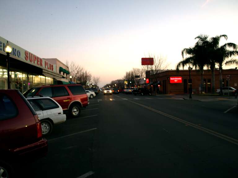 Main Street in downtown Delano, California, between 13th Avenue and 12th Avenue. View from the northbound lane of Main Street, looking southeast.
This photograph was taken with an Olympus E-510 DSLR camera and edited (color balance, saturation,