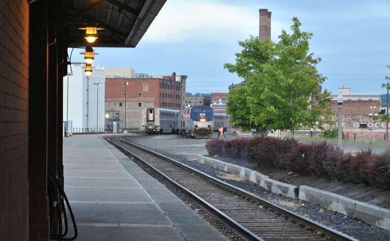This is a scene from Spokane Amtrak station where the Westbound Empire Builder is getting reconfigured This part is waiting for the locomotives on the right to be attached before it continues on to Portland OR.

This photo was taken for and added to