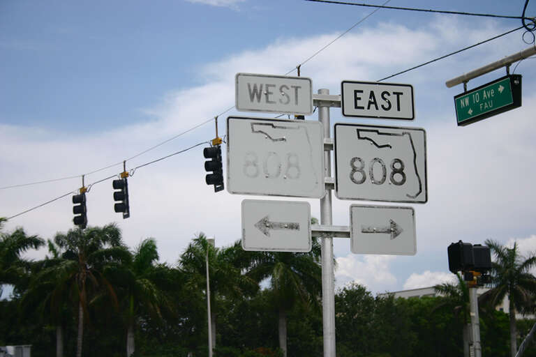 Usually, these newer signs peel, not fade. Glades road by Florida Atlantic University, in Boca Raton.
