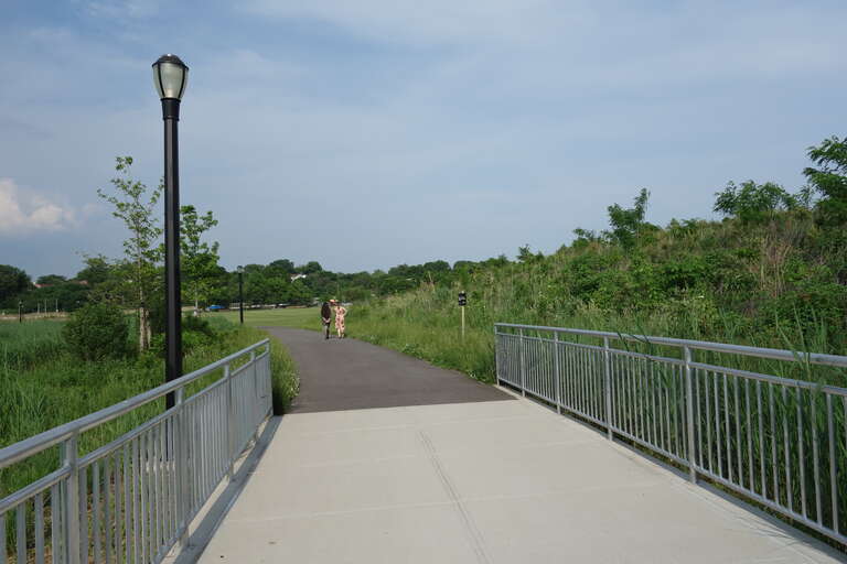 A newly-constructed footbridge on the promenade around Meadow Lake in the Meadow Lake section of Flushing Meadows–Corona Park, on Meadow Lake Drive near Jewel Avenue / 69th Road between Forest Hills and Queensboro Hill, Queens. The bridge crosses a
