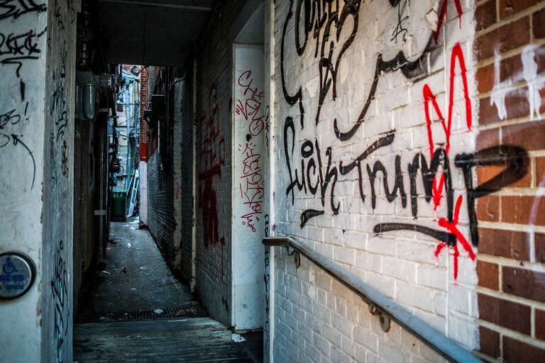 A message for the President on the wall of a narrow alley in Iowa City.