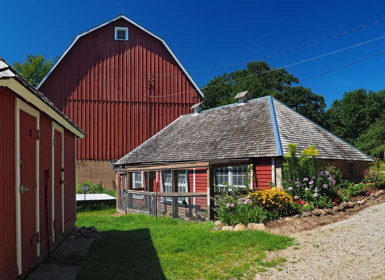 Holz Farm, 4665 Manor Dr, Eagan, Minnesota, USA.  Contributing properties left to right are the milk &amp;amp; pump house, stock tank, barn, and chicken coop, viewed from the east.