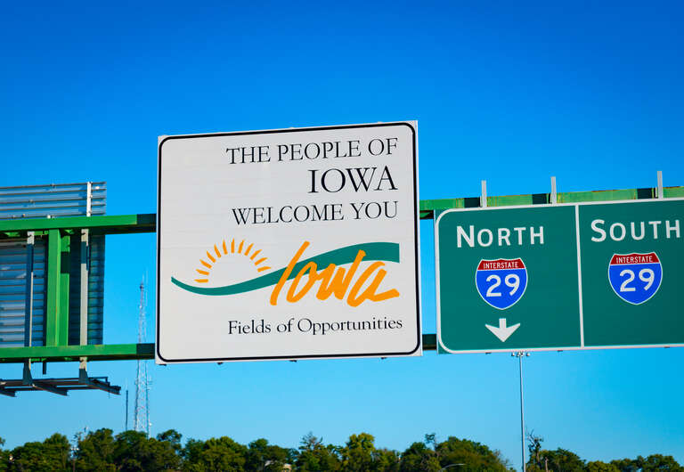 The People of Iowa Welcome You - Fields of Opportunties, reads a sign at the Iowa state line, near Sioux City, Iowa.