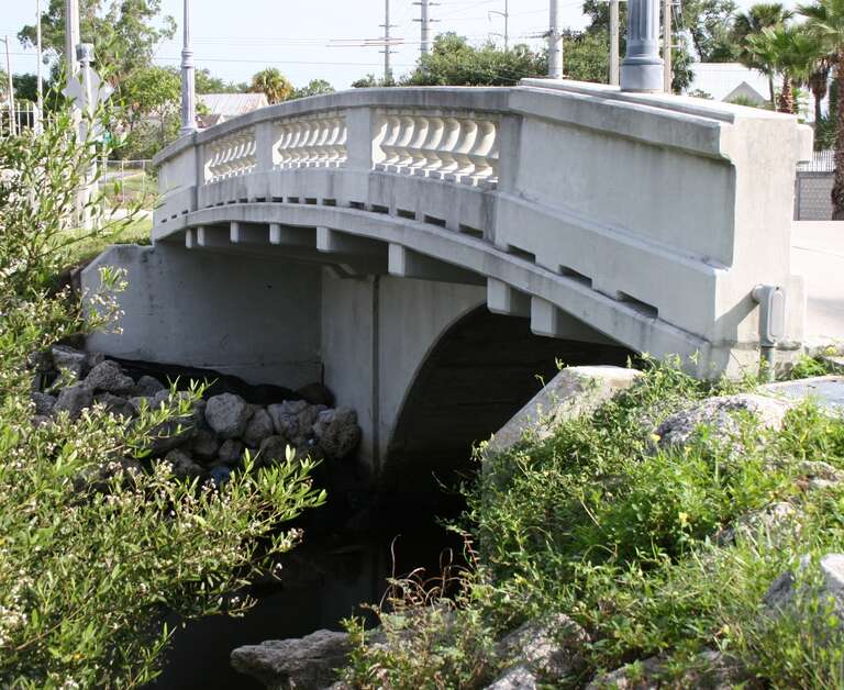 Historic Moores Creek Bridge located in Fort Pierce, Florida.   The bridge was built in 1925 by the Luten Bridge Company and is listed as a registered historic site.  The bridge is locally known as Tickle Tummy Hill due to its high arch compared to