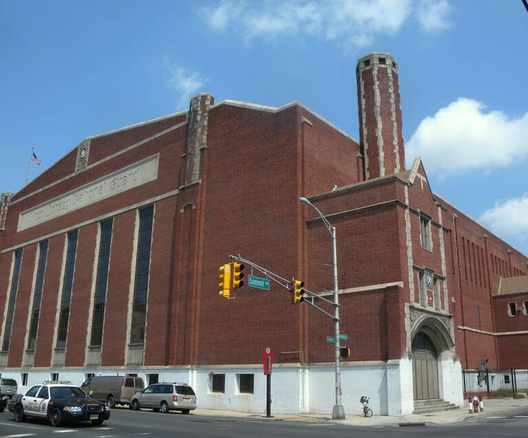 Looking northwest across Summit Avenue and Montgomery Street at armory on a sunny midday.