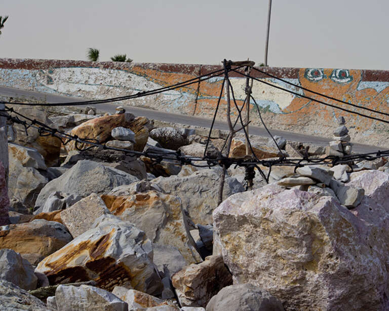 These rocks are at the bottom of the Galveston seawall near where 61st Street runs into Seawall Blvd. Hurricane Ike had pretty much wiped out the beach along the seawall, so Galveston imported a jillion or so tons of sand to replenish the beach.