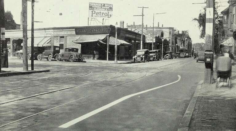 Streetcar tracks on Prospect Street at the intersection with Hampshire Street in the 1920s. A yellow clearance line warns auto drivers to stay off streetcar tracks.