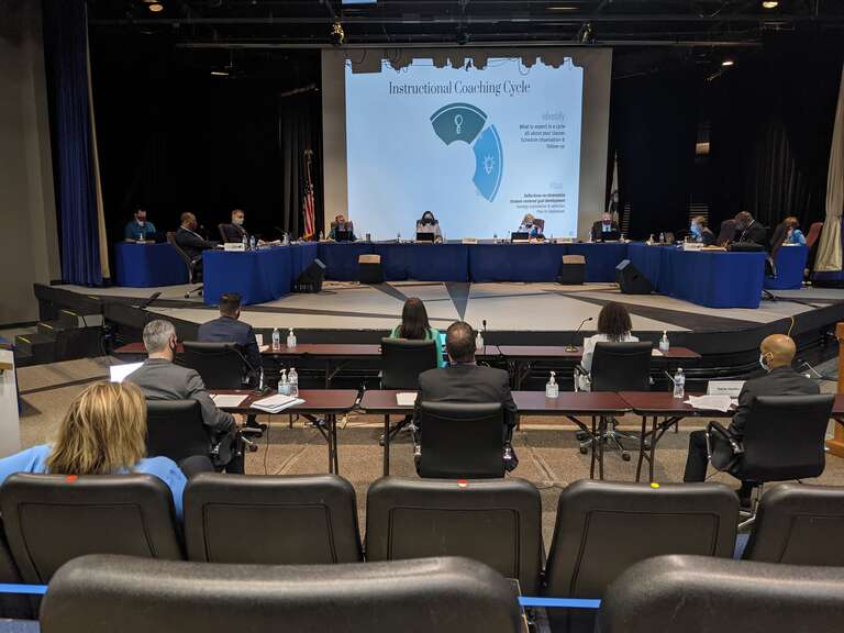 The Township High School District 211 Board of Education receives a presentation on Curriculum Development and Professional Learning during its May 13, 2021 meeting at Hoffman Estates High School. Sitting at the long table on the stage, from left to