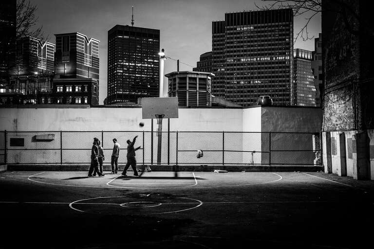 500px provided description: Some guys playing Basketball in front of the Boston Skyline [#Street ,#Night ,#BW ,#Basketball ,#Boston]