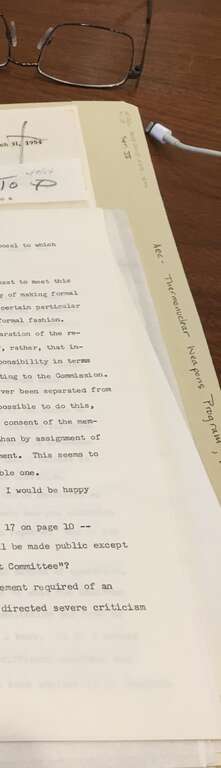A researching inspecting a folder from the Papers of Henry DeWolf Smyth at the library of the American Philosophical Society, Philadelphia.  This particular folder portion relates to Smyth's time on the Atomic Energy Commission and matters concerning