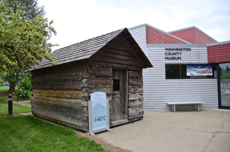 The old Washington County Jail, a log building that was in use as a jail from 1853 to 1870, in front of the Washington County Museum, on Portland Community College's Rock Creek Campus.