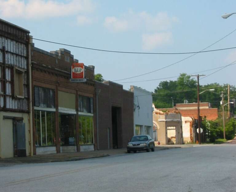 Businesses on North Railroad Avenue in downtown Opelika, Alabama.  The ruins of the Renfroe Opera House are evident at the beginning of the next block.
Photo taken by Lissoy, July 9, 2005.
