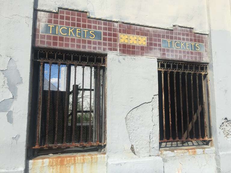 Ticket windows Hinchcliffe stadium,  interior growth of trees and growth in background