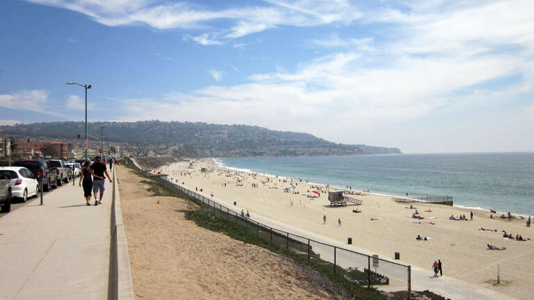View facing south on Esplanade at G Street (approximately) in Redondo Beach of Torrance Beach with Palos Verdes in background.