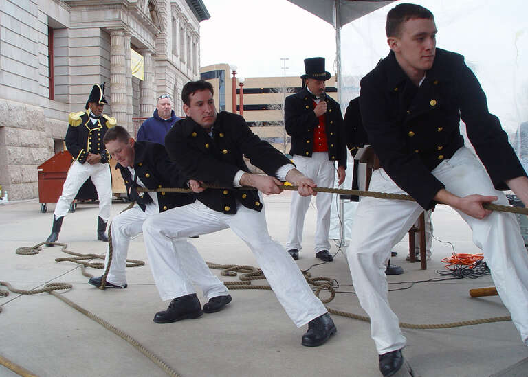Colorado Springs, Colo. (Mar. 3, 2004) - Seaman William Crandell, Seaman Christopher Cobb and Seaman Anthony Kizer heave hard on a 5,600-pound, 1812-era Naval long gun as Cmdr. Lewin C. Wright, Commanding Officer, USS Constitution, looks on during a