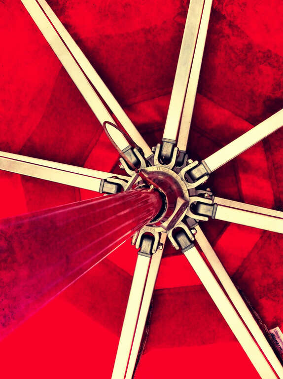 500px provided description: Bright abstraction of a picnic table umbrella taken with an iPhone. [#red ,#umbrella ,#abstract]