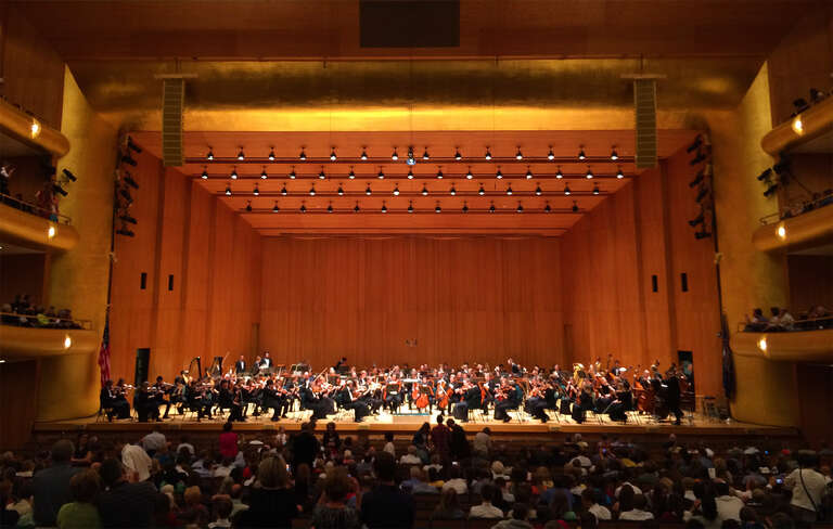 The Utah Symphony seated on stage at Abravanel Hall in Salt Lake City, Utah, USA.