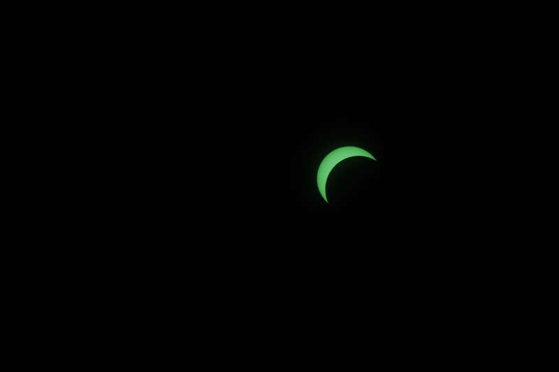 The 2017 solar eclipse, as viewed through a 300mm lens with a welding helmet filter on top of it. (Note the sunspots on the left.)
