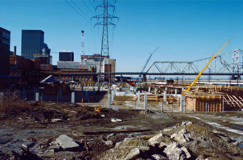 Looking W from near what will later be the intersection of Witherspoon St. and Bingham Way .
Witherspoon St. parking garage under construction.
Clark Bridge in right distance.
Ohio River mile 604.
Louisville, Kentucky.
January 1988.
File #