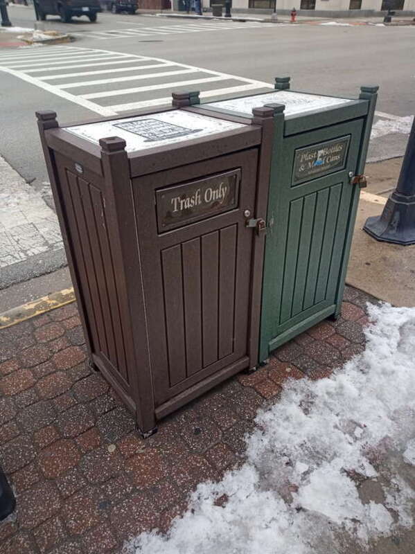 Gray plastic waste container divided between &quot;trash only&quot; and &quot;plastic bottles and metal cans&quot; in downtown Springfield, Illinois.
