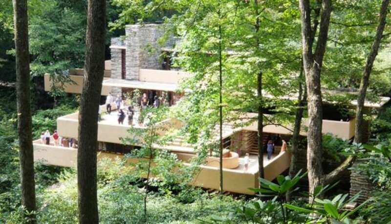 A photograph of the Frank Lloyd Wright designed house Falling Water from the walking trail on the opposite side of the river.